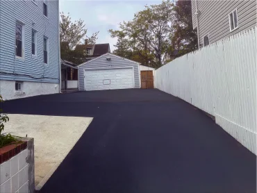 Driveway paving crew compacting asphalt in Passaic County NJ